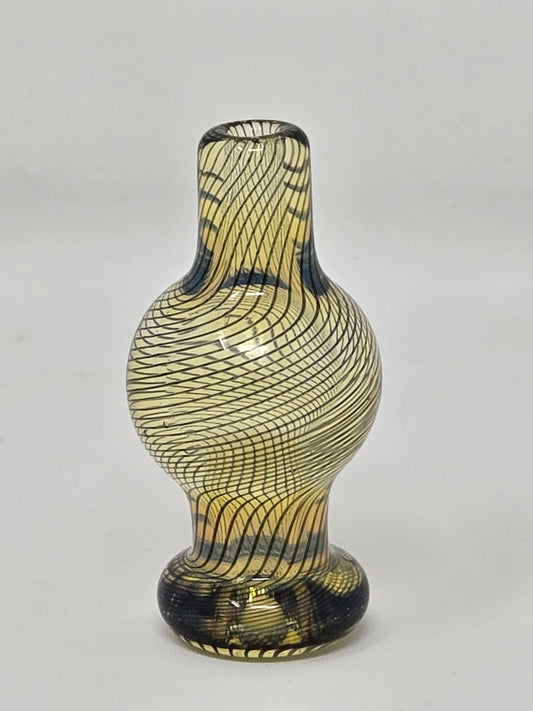 Decorative glass vase with wavy pattern on a white background
