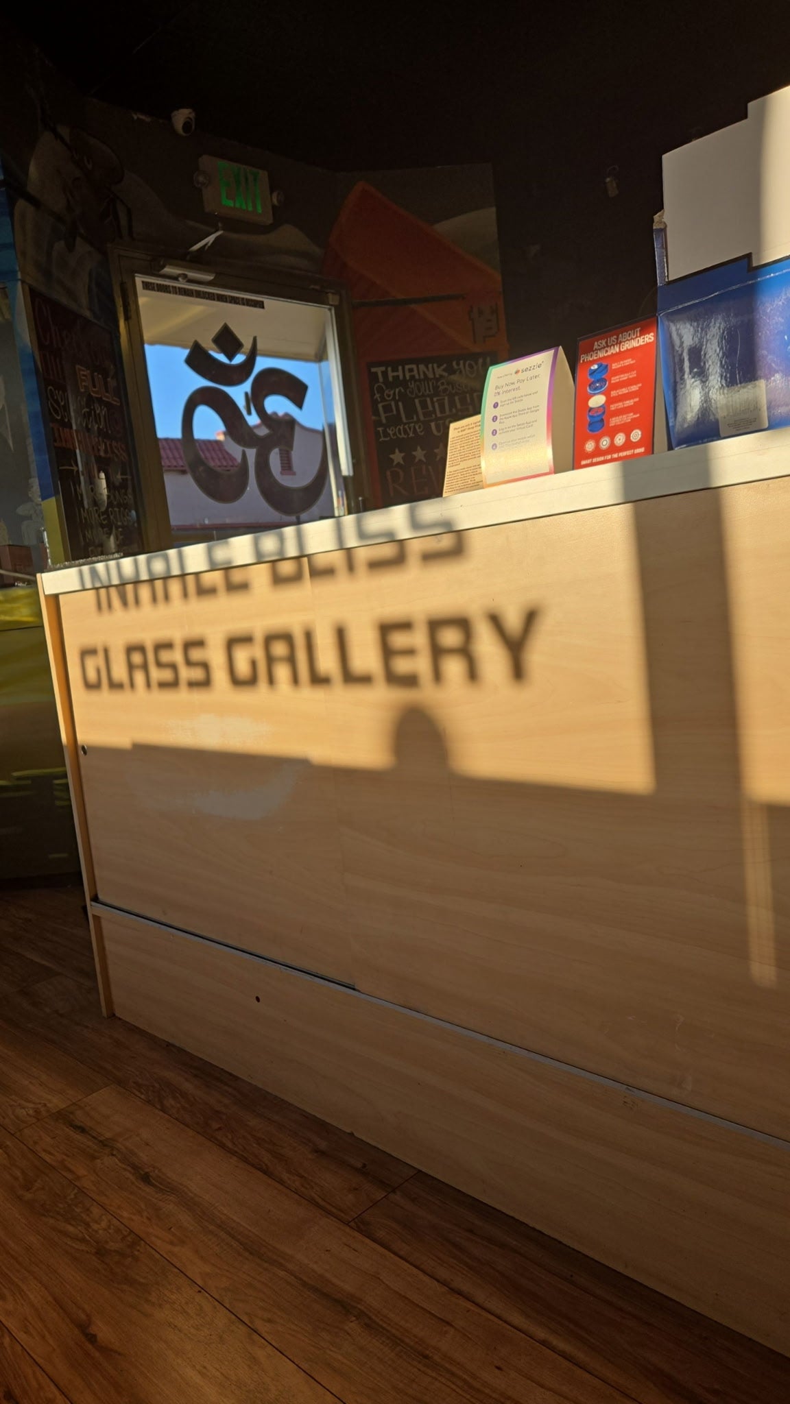 Counter with 'Glass Gallery' sign in a dimly lit room